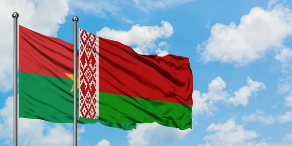 Burkina Faso and Belarus flag waving in the wind against white cloudy blue sky together. Diplomacy concept, international relations. — Stock Photo, Image