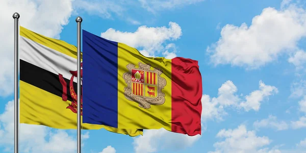 Bandera de Brunéi y Andorra ondeando en el viento contra el cielo azul nublado blanco juntos. Concepto diplomático, relaciones internacionales . — Foto de Stock