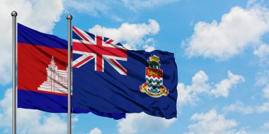 Kamboçya ve Cayman Adaları bayrağı birlikte beyaz bulutlu mavi gökyüzüne karşı rüzgarsal sallayarak. Diplomasi kavramı, uluslararası ilişkiler.