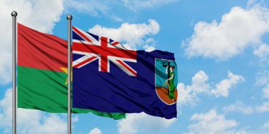 Burkina Faso ve Montserrat bayrağı birlikte beyaz bulutlu mavi gökyüzüne karşı rüzgarda sallayarak. Diplomasi kavramı, uluslararası ilişkiler.