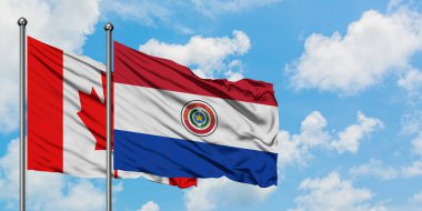 Kanada ve Paraguay bayrağı birlikte beyaz bulutlu mavi gökyüzüne karşı rüzgarda sallayarak. Diplomasi kavramı, uluslararası ilişkiler.