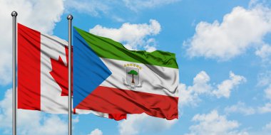 Kanada ve Ekvator Ginesi bayrağı birlikte beyaz bulutlu mavi gökyüzüne karşı rüzgarda sallayarak. Diplomasi kavramı, uluslararası ilişkiler.