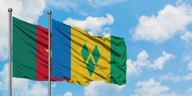 Kamerun ve Saint Vincent ve Grenadinler bayrağı birlikte beyaz bulutlu mavi gökyüzüne karşı rüzgarda sallayarak. Diplomasi kavramı, uluslararası ilişkiler.