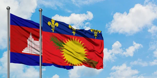 Bandera de Camboya y Guadalupe ondeando en el viento contra el cielo azul nublado blanco juntos. Concepto diplomático, relaciones internacionales . — Foto de Stock