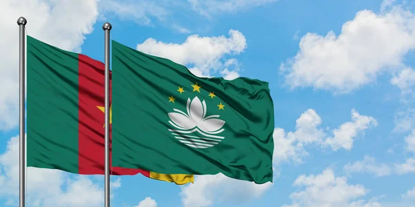 Cameroon and Macao flag waving in the wind against white cloudy blue sky together. Diplomacy concept, international relations.