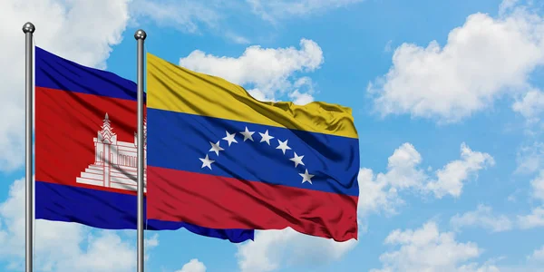 Cambodia and Venezuela flag waving in the wind against white cloudy blue sky together. Diplomacy concept, international relations. — Stock Photo, Image