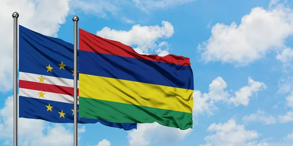 Cape Verde and Mauritius flag waving in the wind against white cloudy blue sky together. Diplomacy concept, international relations. — Stock Photo, Image
