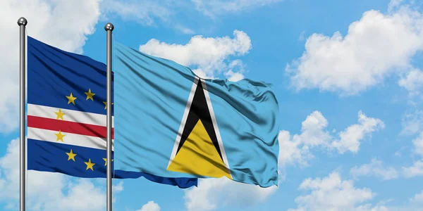 Bandera de Cabo Verde y Santa Lucía ondeando en el viento contra el cielo azul nublado blanco juntos. Concepto diplomático, relaciones internacionales . — Foto de Stock