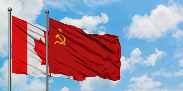 Canada and Soviet Union flag waving in the wind against white cloudy blue sky together. Diplomacy concept, international relations. — Stock Photo, Image