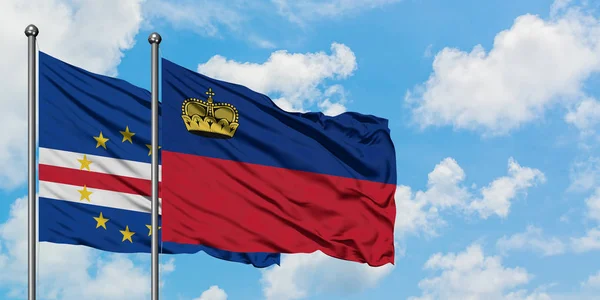 Bandera de Cabo Verde y Liechtenstein ondeando en el viento contra el cielo azul nublado blanco juntos. Concepto diplomático, relaciones internacionales . — Foto de Stock