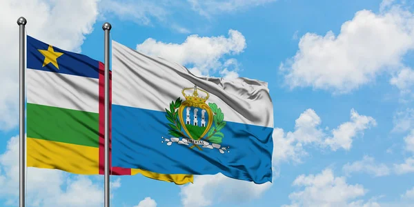 Central African Republic and San Marino flag waving in the wind against white cloudy blue sky together. Diplomacy concept, international relations. — Stock Photo, Image