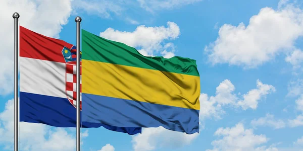 Chorvatsko a Gabon se ve větru mávaly proti bílé oblačné obloze. Diplomacie, mezinárodní vztahy. — Stock fotografie