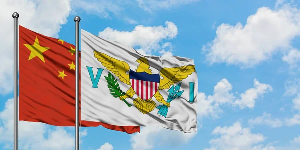 China and United States Virgin Islands flag waving in the wind against white cloudy blue sky together. Diplomacy concept, international relations.