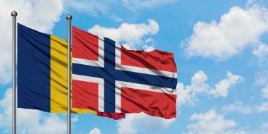 Çad ve Norveç bayrağı birlikte beyaz bulutlu mavi gökyüzüne karşı rüzgarda sallayarak. Diplomasi kavramı, uluslararası ilişkiler.