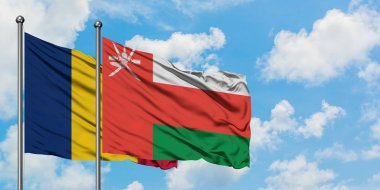 Çad ve Umman bayrağı birlikte beyaz bulutlu mavi gökyüzüne karşı rüzgarda sallayarak. Diplomasi kavramı, uluslararası ilişkiler.