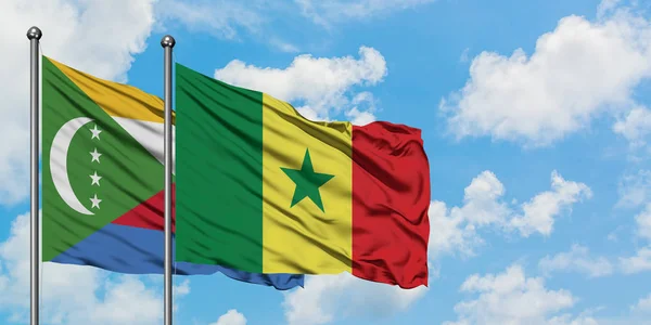 Comoros and Senegal flag waving in the wind against white cloudy blue sky together. Diplomacy concept, international relations. — Stock Photo, Image