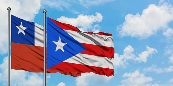 Chile and Puerto Rico flag waving in the wind against white cloudy blue sky together. Diplomacy concept, international relations. — Stock Photo, Image