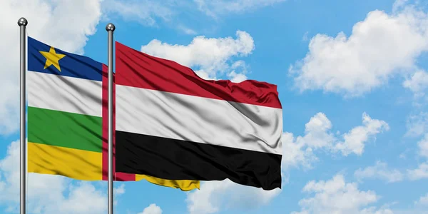 Bandera de República Centroafricana y Yemen ondeando en el viento contra el cielo azul nublado blanco juntos. Concepto diplomático, relaciones internacionales . — Foto de Stock