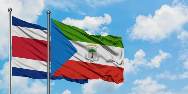 Коста-Ріка і Екваторіальна Гвінея прапор розмахуючи в вітру проти білого хмарного синього неба разом. Концепція дипломатії, міжнародні відносини. — стокове фото