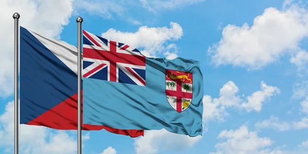 Bandera de la República Checa y Fiyi ondeando en el viento contra el cielo azul nublado blanco juntos. Concepto diplomático, relaciones internacionales . — Foto de Stock
