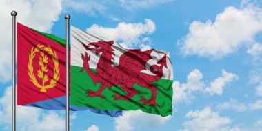 Eritre ve Galler bayrağı birlikte beyaz bulutlu mavi gökyüzüne karşı rüzgarda sallayarak. Diplomasi kavramı, uluslararası ilişkiler.