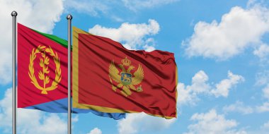 Eritre ve Karadağ bayrağı birlikte beyaz bulutlu mavi gökyüzüne karşı rüzgarda sallayarak. Diplomasi kavramı, uluslararası ilişkiler.