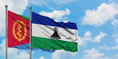Eritre ve Lesotho bayrağı birlikte beyaz bulutlu mavi gökyüzüne karşı rüzgarda sallayarak. Diplomasi kavramı, uluslararası ilişkiler.