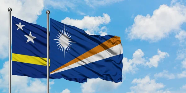 Curacao e Marshall Islands bandiera sventolando nel vento contro bianco cielo blu nuvoloso insieme. Concetto di diplomazia, relazioni internazionali . — Foto Stock