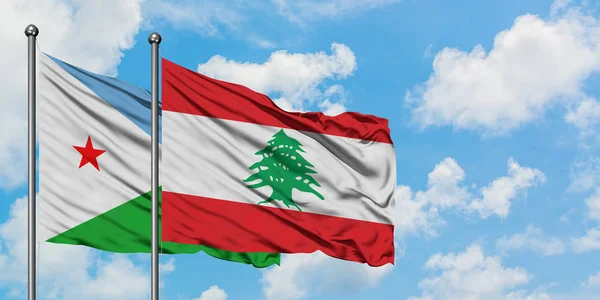 Bandera de Yibuti y Líbano ondeando en el viento contra el cielo azul nublado blanco juntos. Concepto diplomático, relaciones internacionales . — Foto de Stock