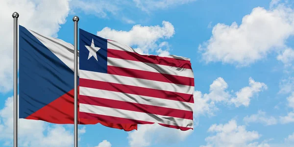 Vlajka České republiky a Libérie mávajících větrem proti bílé zatažené modré obloze. Diplomacie, mezinárodní vztahy. — Stock fotografie
