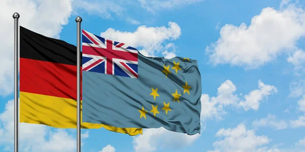 Germany and Tuvalu flag waving in the wind against white cloudy blue sky together. Diplomacy concept, international relations. — Stock Photo, Image