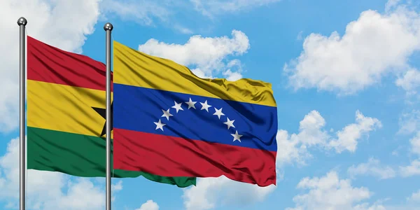 Ghana and Venezuela flag waving in the wind against white cloudy blue sky together. Diplomacy concept, international relations. — Stock Photo, Image