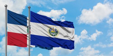 Dominik Cumhuriyeti ve El Salvador bayrağı birlikte beyaz bulutlu mavi gökyüzüne karşı rüzgarda sallayarak. Diplomasi kavramı, uluslararası ilişkiler.