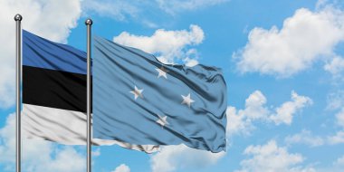 Estonya ve Mikronezya bayrağı birlikte beyaz bulutlu mavi gökyüzüne karşı rüzgarda sallayarak. Diplomasi kavramı, uluslararası ilişkiler.