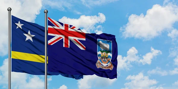 Το Κουρασάο και η σημαία των Νήσων Φώκλαντ χαιρετώντας τον άνεμο ενάντια στον λευκό συννεφιασμένο γαλάζιο ουρανό. Φιλοσοφία της διπλωματίας, διεθνείς σχέσεις. — Φωτογραφία Αρχείου