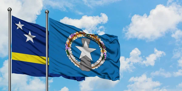 Curacao and Northern Mariana Islands flag waving in the wind against white cloudy blue sky together. Diplomacy concept, international relations. — Stock Photo, Image