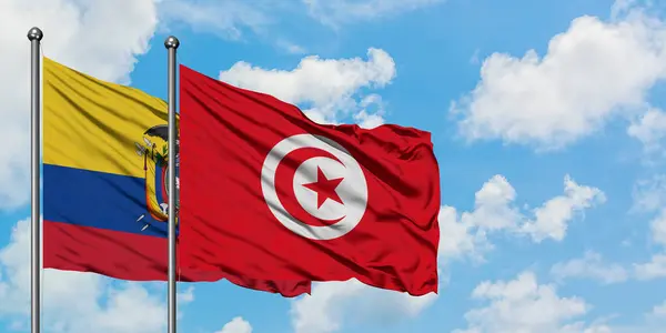 Ecuador and Tunisia flag waving in the wind against white cloudy blue sky together. Diplomacy concept, international relations. — Stock Photo, Image