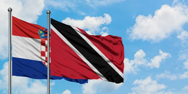 Croazia e Trinidad e Tobago sventolano insieme la bandiera contro il bianco cielo azzurro nuvoloso. Concetto di diplomazia, relazioni internazionali . — Foto Stock