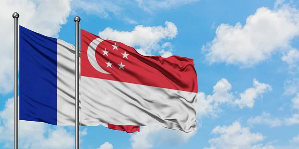 Франція і Сінгапур прапор розмахуючи в вітру проти білого хмарного синього неба разом. Концепція дипломатії, міжнародні відносини. — стокове фото