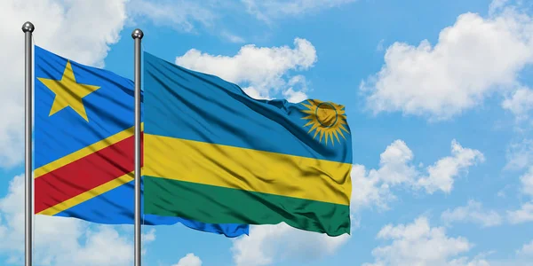 刚果和卢旺达国旗在风中飘扬，与白云蓝天相一起。外交概念、国际关系. — 图库照片
