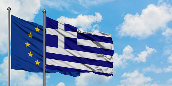 European Union and Greece flag waving in the wind against white cloudy blue sky together. Diplomacy concept, international relations.