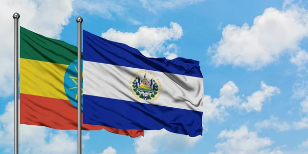 Ethiopia and El Salvador flag waving in the wind against white cloudy blue sky together. Diplomacy concept, international relations. — Stock Photo, Image