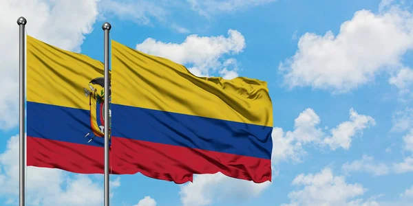 Bandera de Ecuador y Colombia ondeando en el viento contra el cielo azul nublado blanco juntos. Concepto diplomático, relaciones internacionales . — Foto de Stock