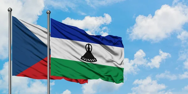 捷克共和国和莱索托国旗在风中飘扬，与白云蓝天相一起。外交概念、国际关系. — 图库照片