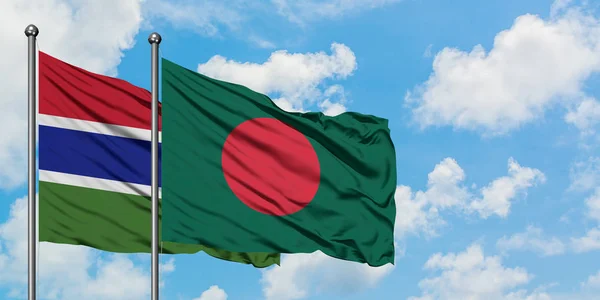 Bandera de Gambia y Bangladesh ondeando en el viento contra el cielo azul nublado blanco juntos. Concepto diplomático, relaciones internacionales . — Foto de Stock