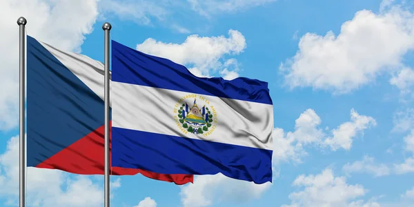 Bandera de República Checa y El Salvador ondeando en el viento contra el cielo azul nublado blanco juntos. Concepto diplomático, relaciones internacionales . — Foto de Stock