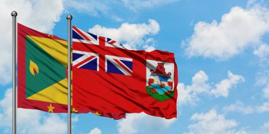 Grenada ve Bermuda bayrağı birlikte beyaz bulutlu mavi gökyüzüne karşı rüzgarda sallayarak. Diplomasi kavramı, uluslararası ilişkiler.