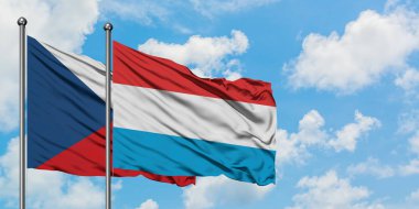 Çek Cumhuriyeti ve Lüksemburg bayrağı birlikte beyaz bulutlu mavi gökyüzüne karşı rüzgarda sallayarak. Diplomasi kavramı, uluslararası ilişkiler.