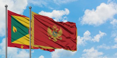 Grenada ve Karadağ bayrağı birlikte beyaz bulutlu mavi gökyüzüne karşı rüzgarda sallayarak. Diplomasi kavramı, uluslararası ilişkiler.