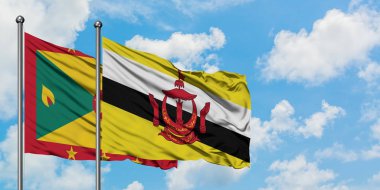 Grenada ve Brunei bayrağı birlikte beyaz bulutlu mavi gökyüzüne karşı rüzgarda sallayarak. Diplomasi kavramı, uluslararası ilişkiler.